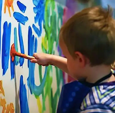 boy holding a paint brush